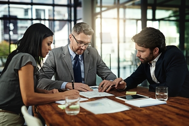 Attorney discussing paperwork with clients